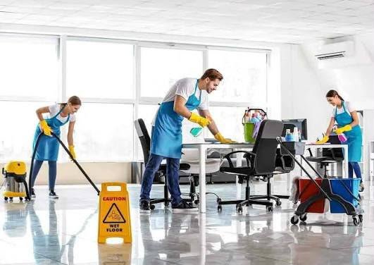 Professional cleaning staff working in a bright commercial space